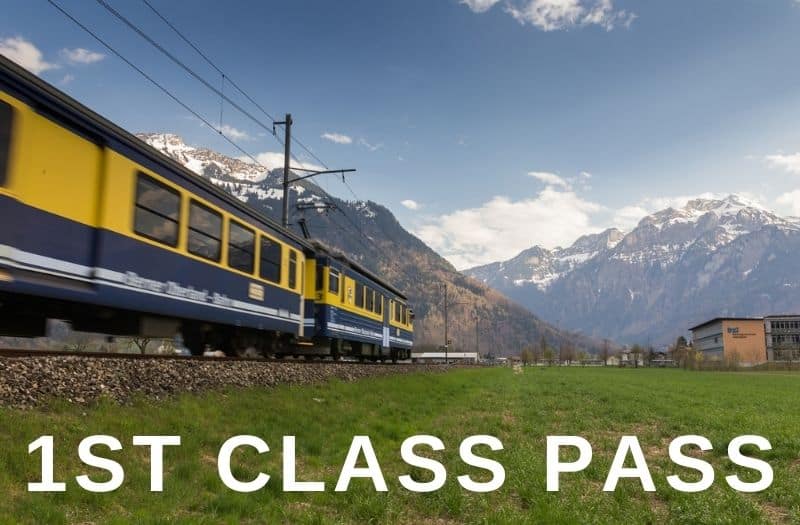 Blue and yellow train with mountain backdrop