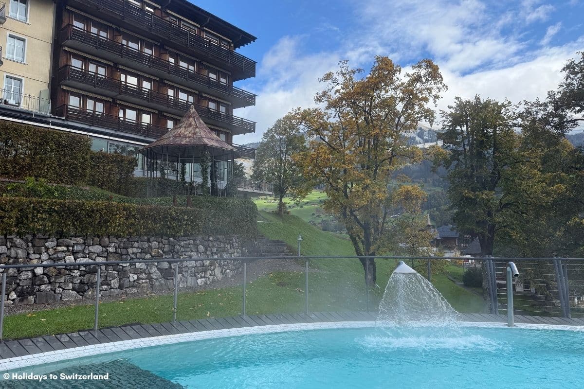 View to hotel from outdoor pool at Lenkerhof Gourmet Spa Resort